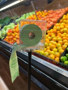 Grocery store shopper using biodegradable produce bags.