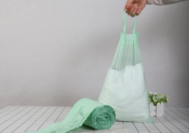 Biodegradable trash bag with drawstring in kitchen waste bin