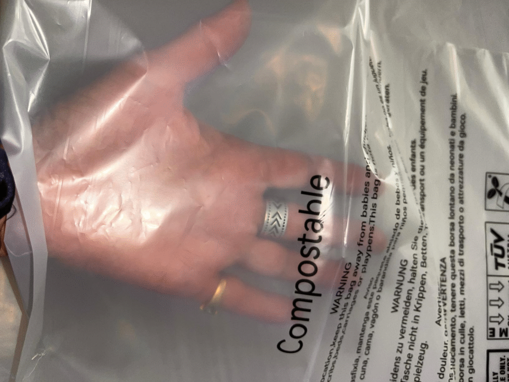 Compostable Garment Bags: The Sustainable Alternative to Plastic Polybags for Fashion Brands (2026 Guide) 3 Custom printed compostable clothing bags with logo, certification marks, hanger hole and adhesive flap options